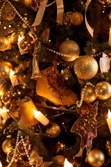 Close up of a decorated Christmas Tree with colourful decorations and garland lights, bokeh. Festive and New Year concept.