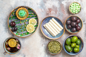 top view little cake with fruits and tea on the light background dessert sweet biscuit