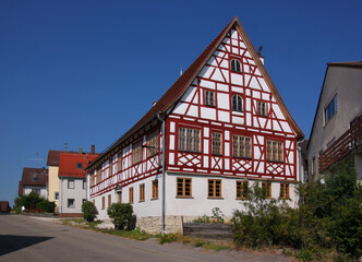 A half-timbered side-gabled wooden residential house in the old village of Nellingen in Germany