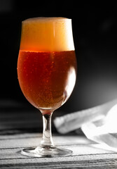 A glass of delicious craft beer on an authentic table cloth.