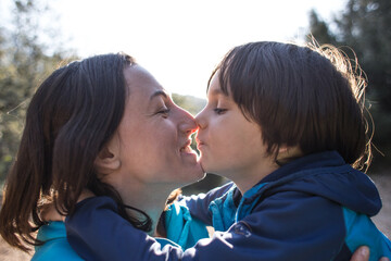 Fototapeta premium Child and mother touch their noses.