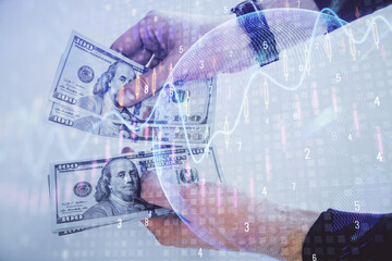 Multi exposure of financial graph drawing hologram and USA dollars bills and man hands. Analysis concept.