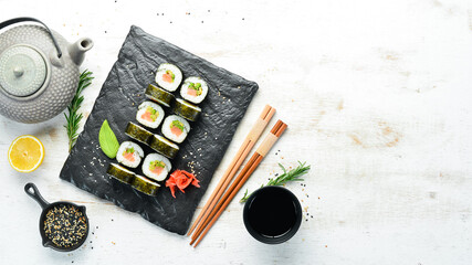 Sushi rolls with avocado and salmon. Classic Japanese sushi. Top view. Free space for your text.