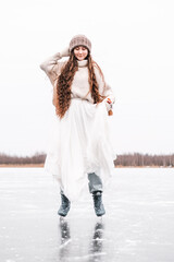 Woman ice skating outdoors on a pond. Outdoors lifestyle portrait of girl in figured skates....