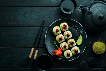 Green Sushi rolls - with eel fish and green Tobiko caviar. Pieces of delicious sushi. Top view.