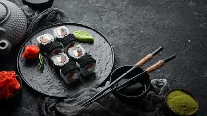 Sushi rolls -Fila Black with black caviar, salmon and cheese. Top view. Free space for your text.