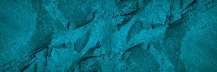 Abstract turquoise background. Monochrome blue stone background. Toned rock texture. Wide banner with copy space.