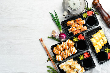 Food delivery. Set of sushi rolls with fish, cheese and sauces. Japanese traditional food. Top view.