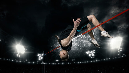 Fototapeta na wymiar Man in action of high jump. Sports banner