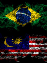 Brazil, Brazilian vs Malaysia, Malaysian smoky mystic flags placed side by side. Thick colored silky abstract smoke flags.
