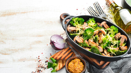 Baked mushrooms and broccoli with cheese in a black pan. Top view. Free space for your text. Rustic style.