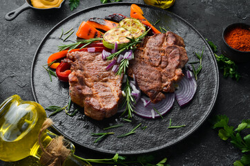 Beef steak. Juicy veal steak with rosemary and spices. Top view. Barbecue.