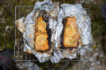 Cooking salmon trout at the campsite.