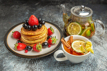 front view yummy pancakes with fruits and tea on light background fruit sweet breakfast