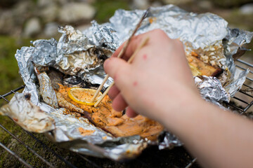Cooking salmon trout at the campsite.