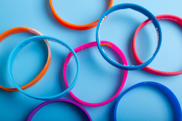 Colorful bracelets on blue background