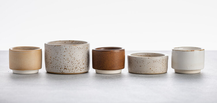 handmade ceramics, empty craft ceramic bowls on light background 