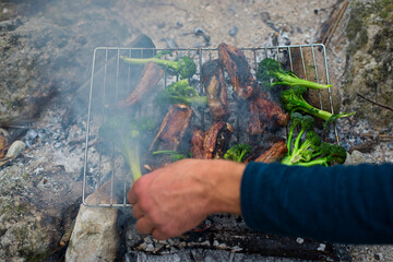 Pork ribs cooked on the grill with broccoli.