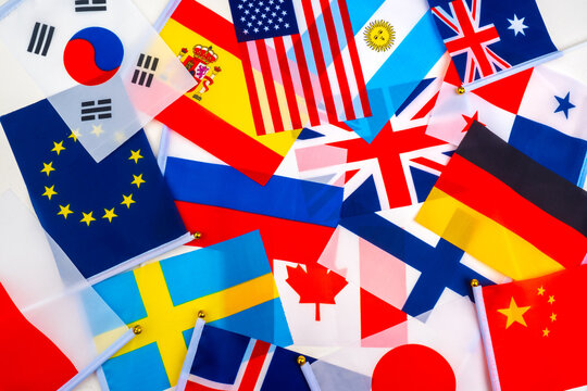 Flags of different countries are mixed. State flags are scattered on the table. Flags as a symbol of international relations. International Political Conference. Negotiations between countries