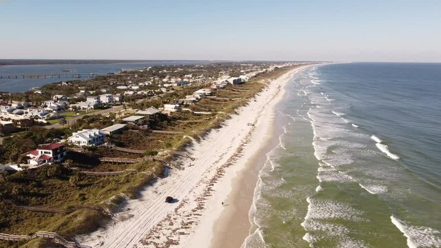 Off road vehicle driving on the beach sand Crescent FL USA