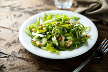 Healthy arugula salad with celery and walnut
