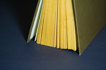 old book with yellowed pages on a black background