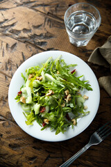 Healthy arugula salad with celery and walnut