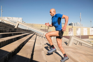 Sportsman running up stairs in a urban landscape