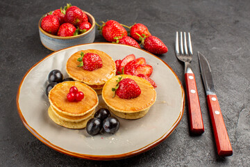 front view little yummy pancakes with fruits on the dark background pie fruit cake