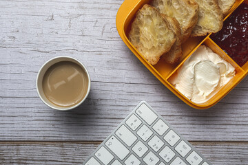 breakfast at workplace on work table from above