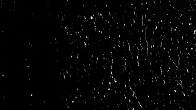 Background with raindrops on a black background for overlay to create mood. Light water on glass isolated on a dark background.