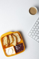 breakfast at workplace on work table from above