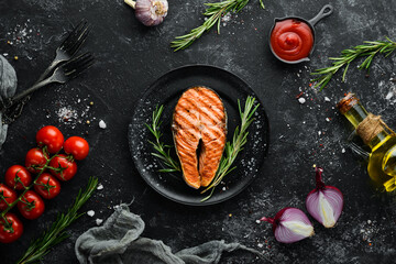 Grilled salmon steak with rosemary and spices. Top view. Free space for your text.