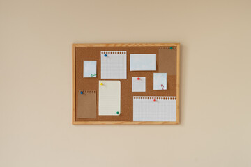 cork board with blank papers wooden frame. notes. colourful pin and paperclips . reminder. pin...