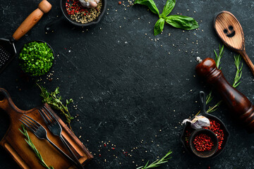 Black stone culinary background with vegetables and spices. Top view. Rustic style.