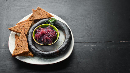 Buckwheat blood sausage and caramelized sweet onions with black bread. Trout. Top view. free space...