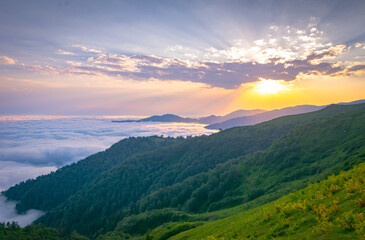 Stunning sunset above the horizon and clouds above Georgia Gomismta mount