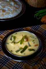 Delicious vegetable stew in a bowl on a black background