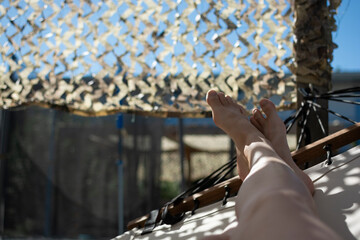Relaxing outdoor garden scene with white hammocks surrounded by greenery in a green summer garden