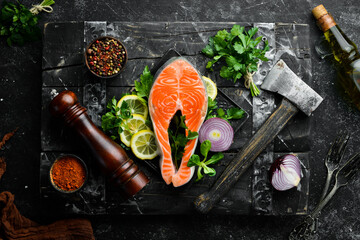 Raw fish steak with parsley and lemon on the table. Salmon Top view. Free space for your text. Rustic style.