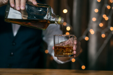 Close-up Barman pouring whiskey whiskey glass beautiful night