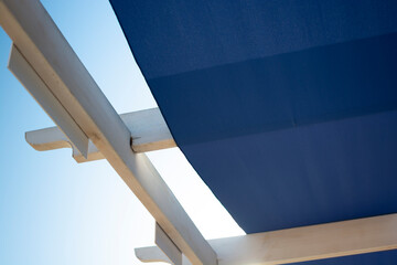 Sunny summer lakeside beach with empty loungers and umbrellas near Sukko, Russia