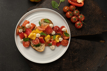 Vegan vegetable salad with bell peppers, cherry tomatoes, basil, capers, sun-dried tomatoes with white bread and peanut sauce..