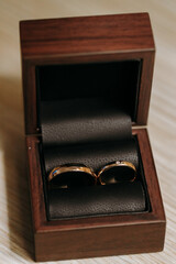Two wedding rings in a wooden box.