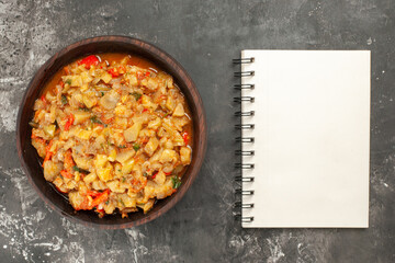 top view roasted eggplant salad a notebook on dark background