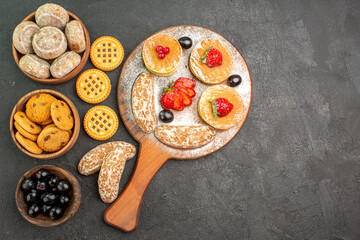 top view tasty pancakes with sweet cakes and fruits on dark floor cake dessert sweet
