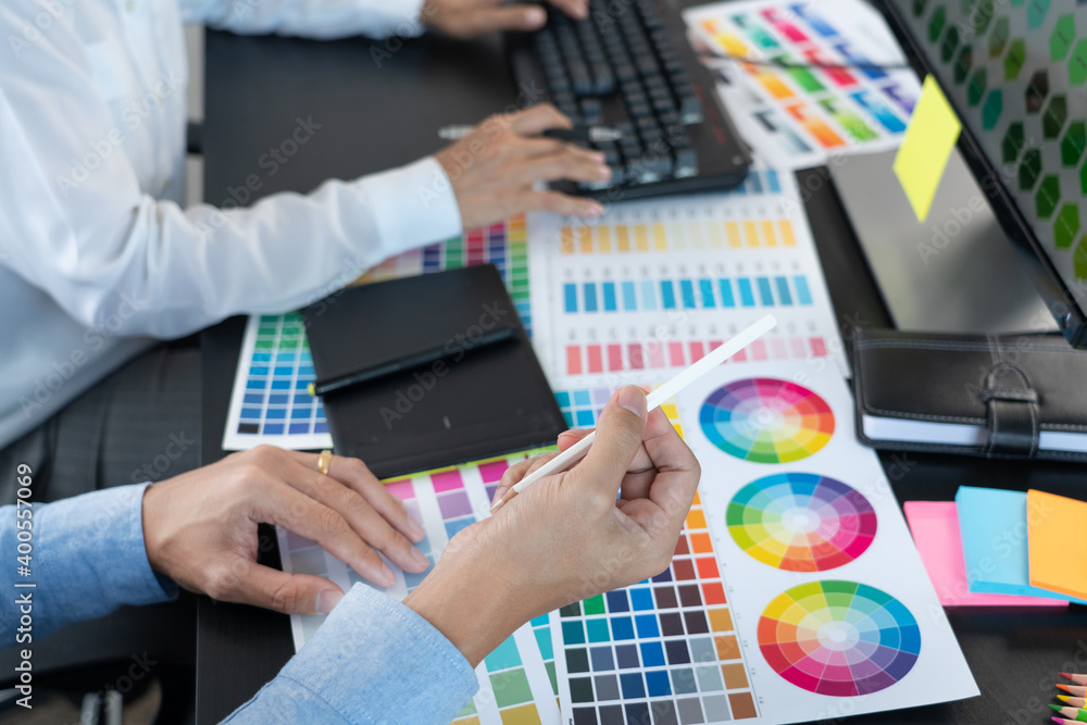 Aufkleber graphic designer or creative working together coloring using graphics tablet and a stylus at desk wi