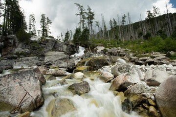 Waterfalls of Cold stream in Great Cold Valley in High Tatras, Slovakia. Cloudy sky.