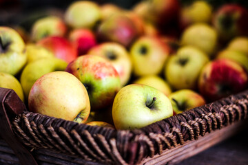 Red and yellow apples in a wooden basket