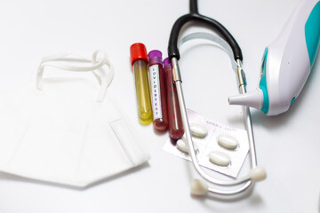 Test tube of blood sample for COVID-19 with doctor equipment on white background